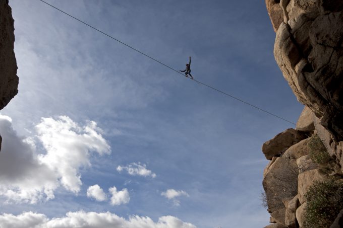 a tightrope walker crossing a gorge